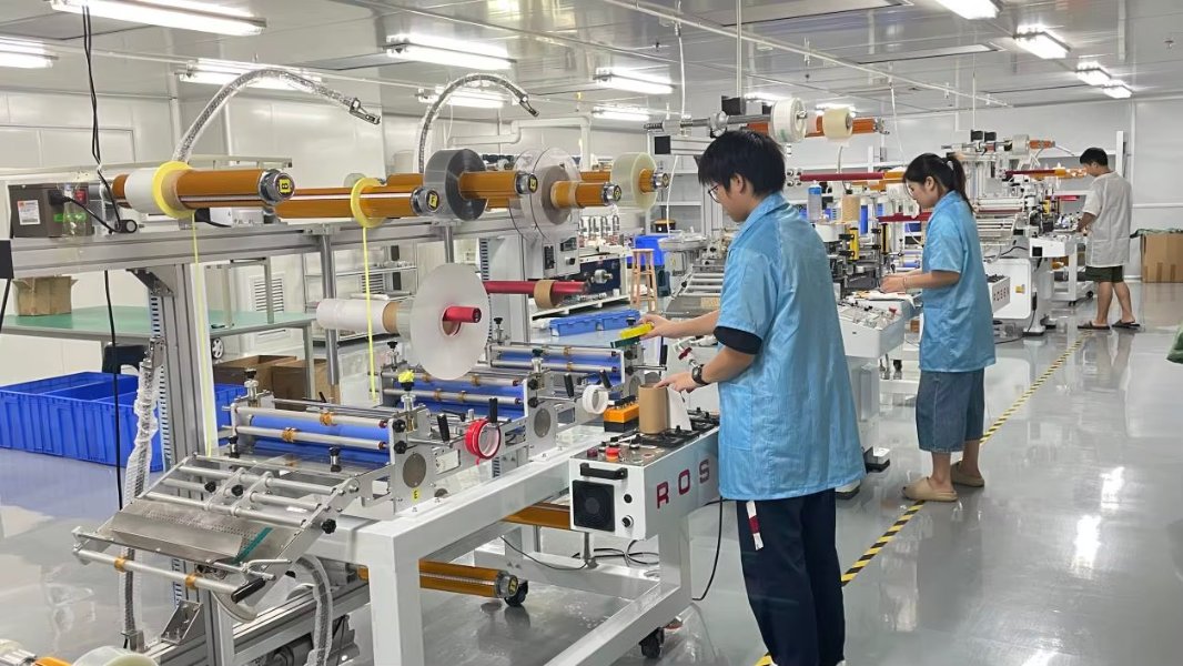 Die-cutting adhesive patches at the MedZen factory in Dongguan
